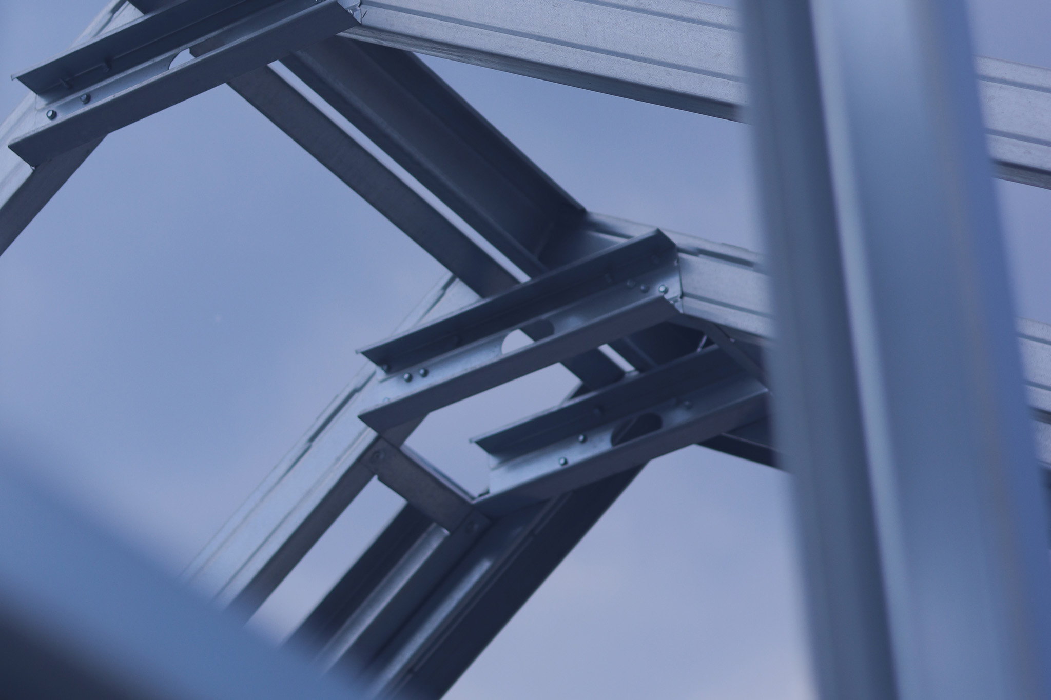 Lightweight steel thin-walled structures. Frames for warehouses, garages or houses. Structure of a steel frame for construction against the sky